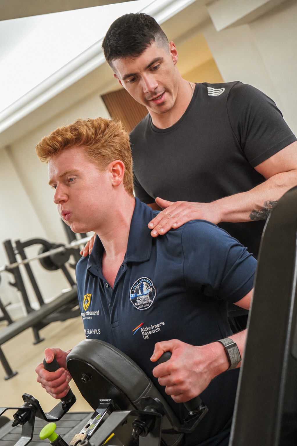 Jayke Izli coaching a client through a controlled machine exercise