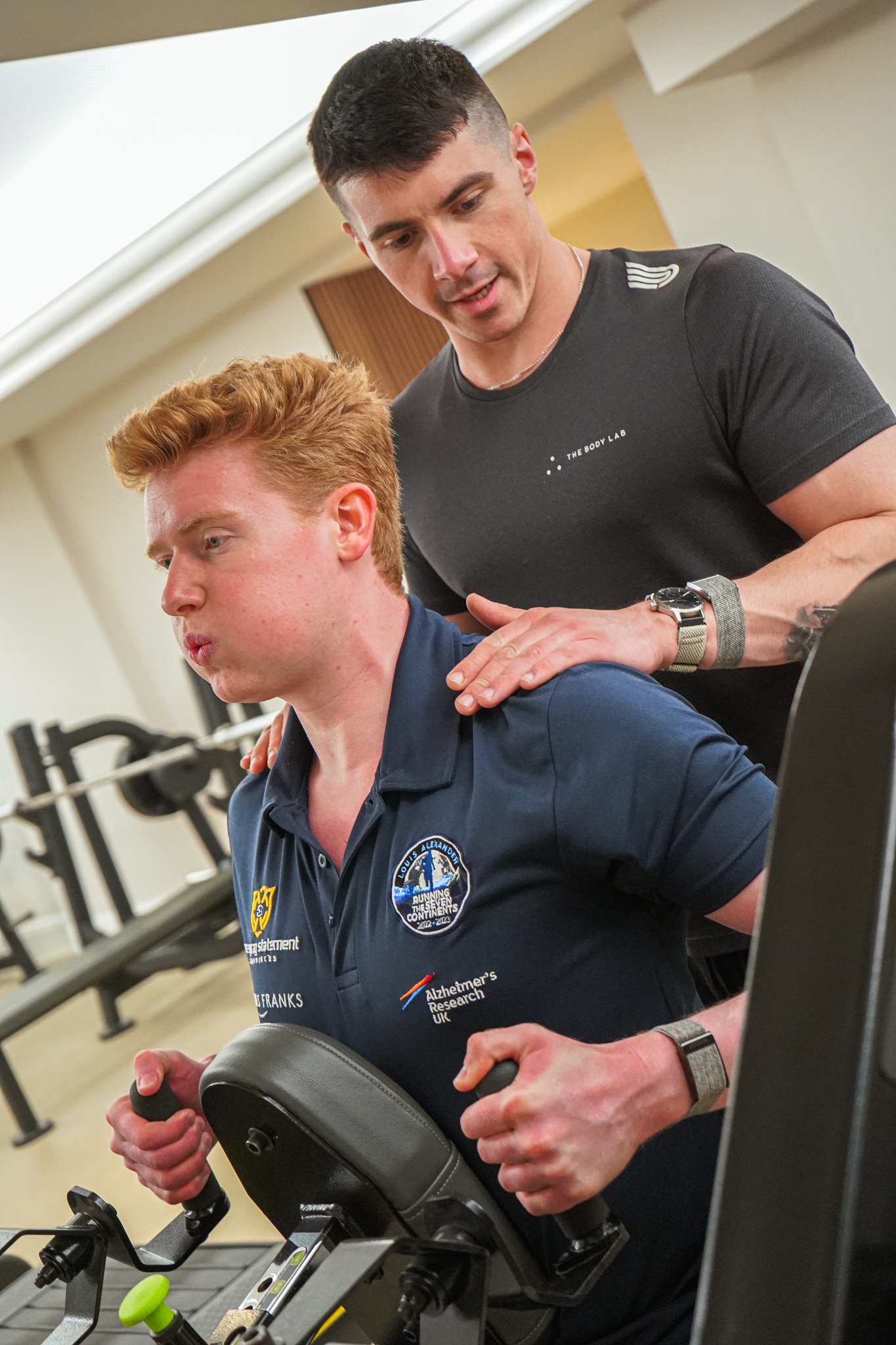 Jayke Izli coaching a client through a controlled machine exercise